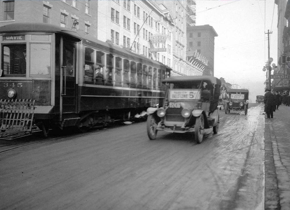 1910s: Taxis and streetcars driving down Granville Street. (Vancouver Archives)