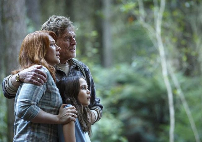 Meecham (Redford) Grace (Howard) and Natalie (Laurence) find Elliot in the forest. Image: Disney