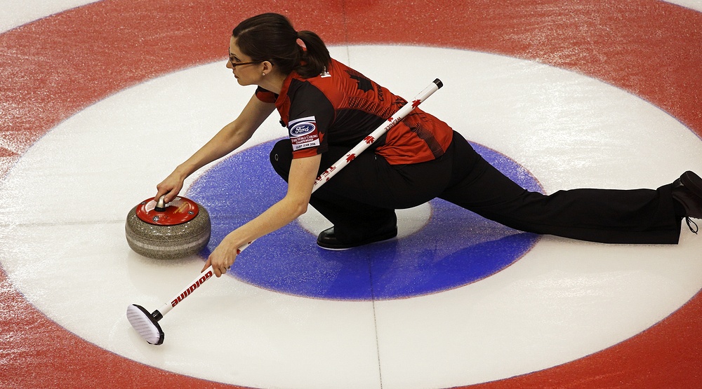 Canada's Lisa Weagle slides through the rings on a stone delivery at the Ford World Women's Curling Championship March 19, 2014 in Saint John, Canada (Jamie Roach/Shutterstock)