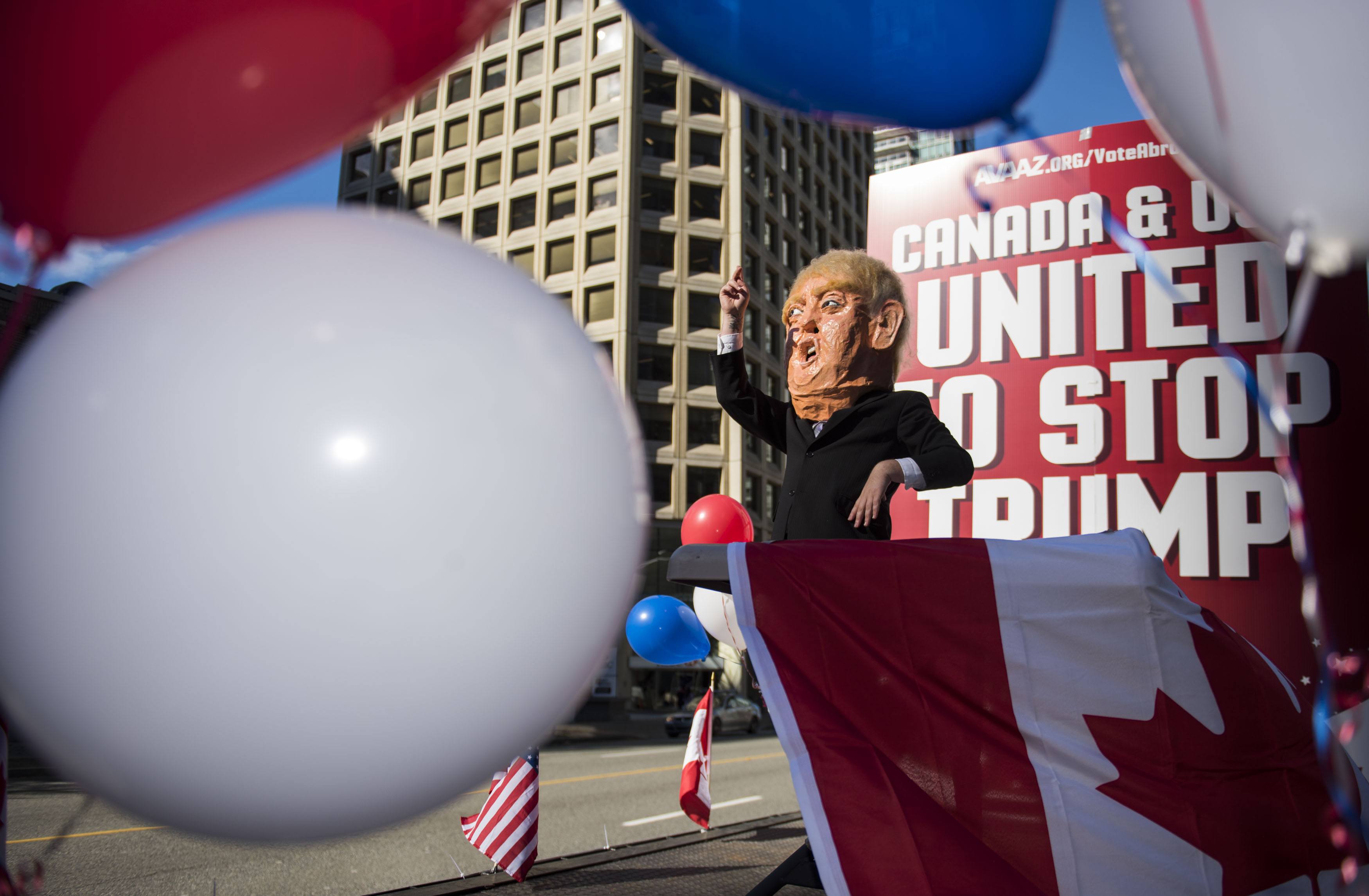 A flat bed “Stop Trump” truck sits outside the new Trump Tower in downtown Vancouver organized by Avaaz to launch a major new campaign to mobilise American expats across Canada to register and vote, in Vancouver, B.C. on Wednesday, October 5, 2016. (THE CANADIAN PRESS IMAGES/Jimmy Jeong)