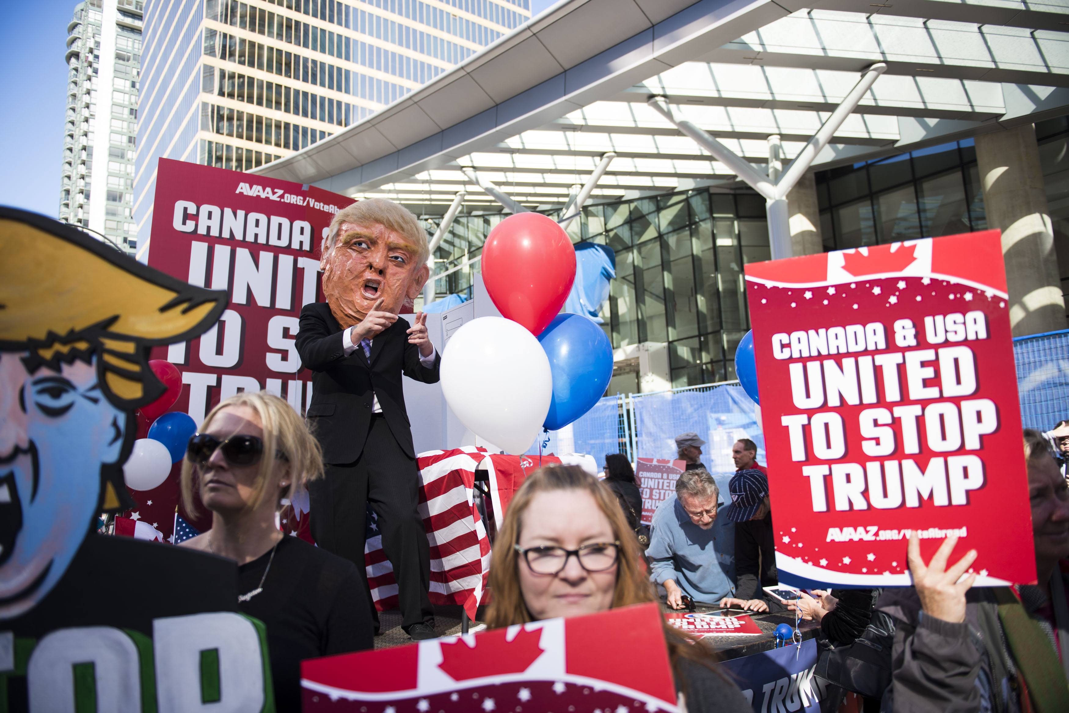 A flat bed “Stop Trump” truck sits outside the new Trump Tower in downtown Vancouver organized by Avaaz to launch a major new campaign to mobilise American expats across Canada to register and vote, in Vancouver, B.C. on Wednesday, October 5, 2016. (THE CANADIAN PRESS IMAGES/Jimmy Jeong)