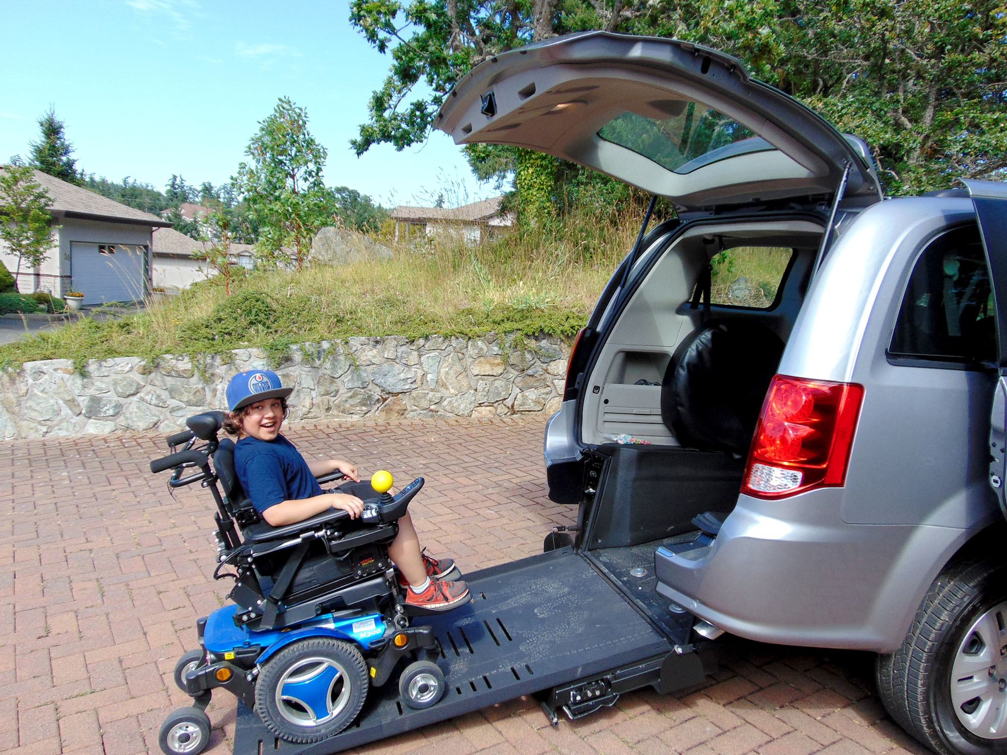 Dacian getting into his family's wheelchair-converted van (Variety)