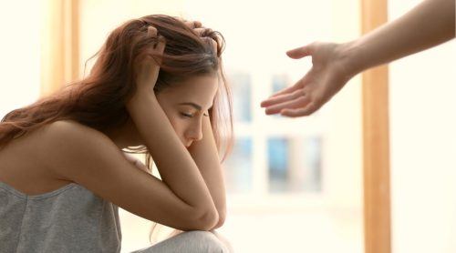 Woman feeling depressed or suicidal getting support and help (Africa Studio/Shutterstock)