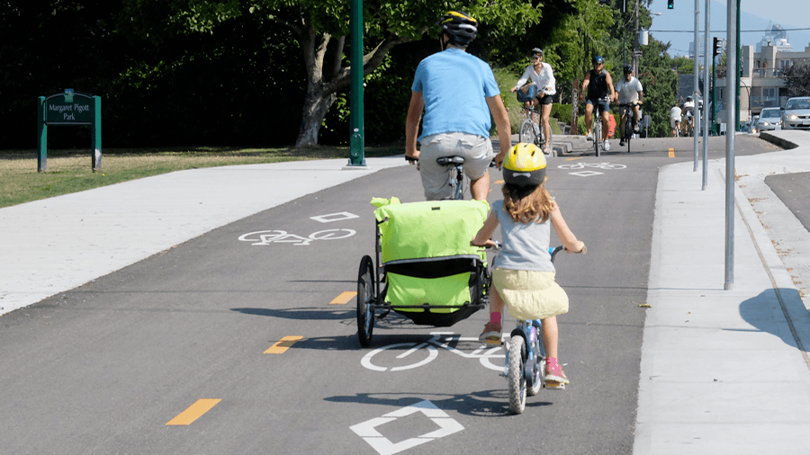 A parent and child cycling on a Vancouver bike path (HUB Cycling)