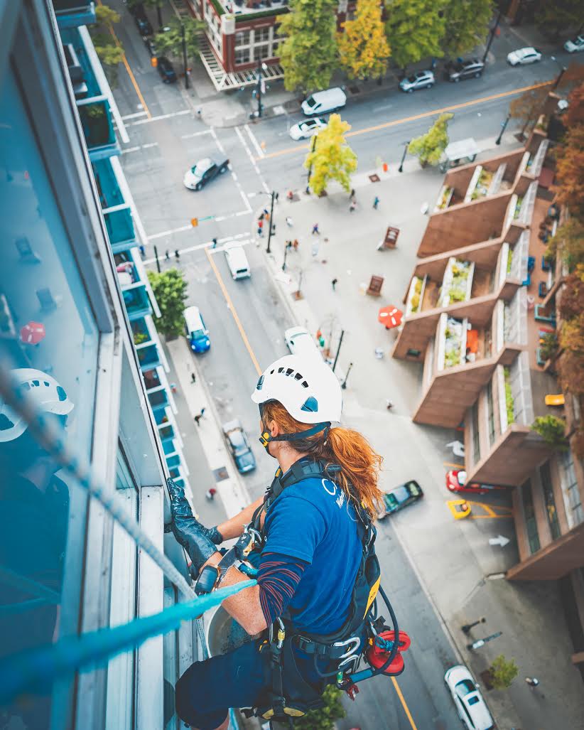 Dominica Myles rappelling down a high-rise building in her new job (Nicolas Guaiquin)