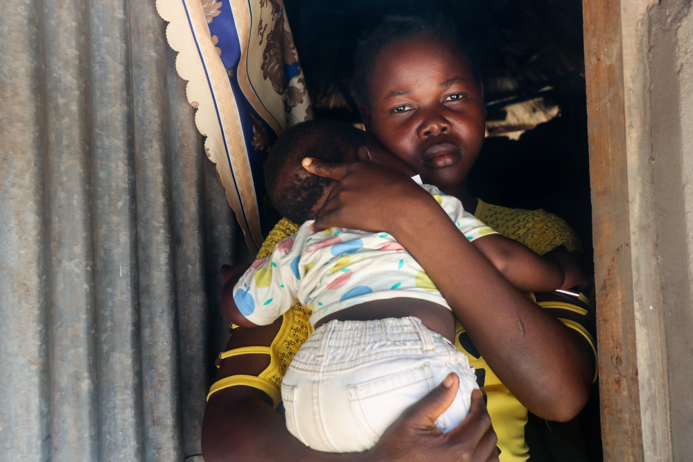 Aniiri with her child in her arms