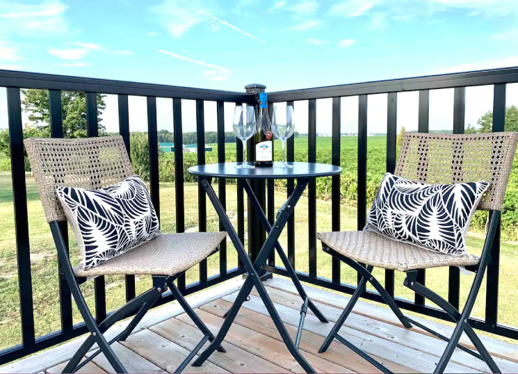 a bristro table with wine glasses on a patio