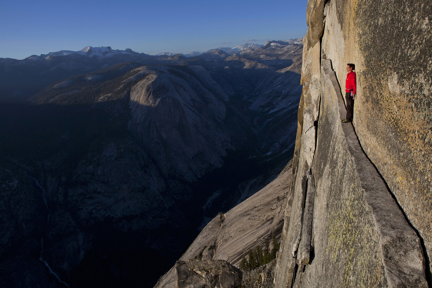 Image: Alex Honnold reenacting his rope-less free climb of the 2,500 ft. Northwest Face of Half Dome (5.12), Yosemite National Park, California, USA. Alex's ascent is arguably the hardest free solo done to date in Yosemite.