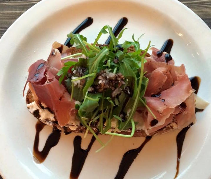 Prosciutto, house-made ricotta, and arugula on toast (Prado Cafe/Facebook)