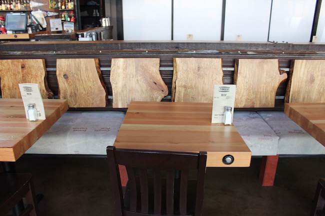 A sawed log serves as bench back, and Canada Post mail bags as the upholstery (Lindsay William-Ross/Vancity Buzz)