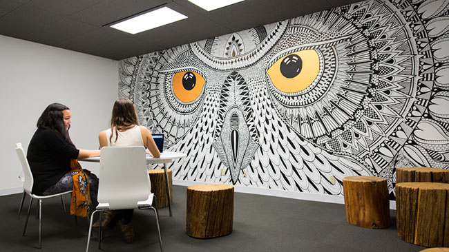 Each meeting room in the new Hootsuite office has been named after a different owl based on their respective sizes. Four rooms have also been adorned with murals. (Hootsuite)